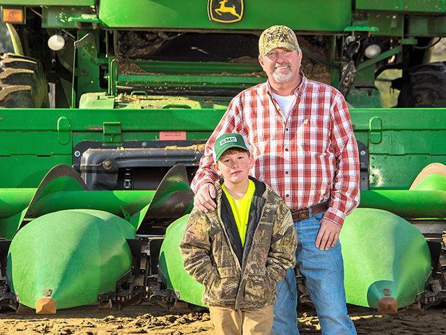 Dan Gause (with son Daniel) gives precision farming the credit for boosting his whole-farm dryland corn averages by 60 bushels to the acre, Image by Fred Salley
